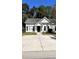 White house with black shutters and a concrete driveway at 106 Hardee Ave, Summerville, SC 29485