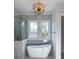 Elegant bathroom with soaking tub and large windows at 1449 Jeremy Cay Ct, Awendaw, SC 29429