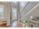 Bright entryway with hardwood floors, staircase, and natural light at 620 Chigwell Springs Ln, Summerville, SC 29486