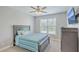 Bright bedroom with a striped comforter and plenty of natural light at 620 Chigwell Springs Ln, Summerville, SC 29486