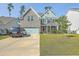 Two-story house with brick and siding exterior, attached garage, and well-manicured lawn at 620 Chigwell Springs Ln, Summerville, SC 29486