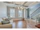 Bright living room with hardwood floors, neutral walls, and a comfy sofa at 620 Chigwell Springs Ln, Summerville, SC 29486