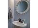 Small bathroom with pedestal sink and round mirror at 1746 Pierpont Ave, Charleston, SC 29414