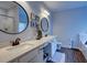 Bathroom boasts double vanity, white cabinets, and large circular mirrors at 1746 Pierpont Ave, Charleston, SC 29414
