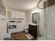 Bathroom with walk-in shower, dark vanity, and washer/dryer at 1746 Pierpont Ave, Charleston, SC 29414