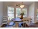 Bright dining area with a round wooden table and white chairs, overlooking the backyard at 1746 Pierpont Ave, Charleston, SC 29414