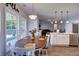 Kitchen features white cabinets, a kitchen island, and an adjacent dining area at 1746 Pierpont Ave, Charleston, SC 29414
