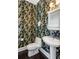 Small powder room with pedestal sink and toilet, featuring floral wallpaper at 3906 Heron Marsh Cir, Johns Island, SC 29455