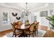 Bright dining room with hardwood floors, chandelier, and staircase view at 3906 Heron Marsh Cir, Johns Island, SC 29455