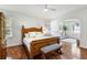 Main bedroom with wooden bed frame, sitting area, and water views at 3906 Heron Marsh Cir, Johns Island, SC 29455