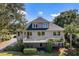 Two-story house with a large deck, spiral staircase, and mature landscaping at 3906 Heron Marsh Cir, Johns Island, SC 29455