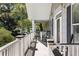 Relaxing front porch with rocking chairs and lush landscaping at 3906 Heron Marsh Cir, Johns Island, SC 29455