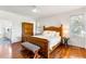 Bedroom with wooden bed frame and hardwood floors, adjacent to bathroom at 3906 Heron Marsh Cir, Johns Island, SC 29455