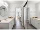 Bright bathroom with double sinks, and a large mirror at 3906 Heron Marsh Cir, Johns Island, SC 29455