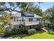 Two-story house with a large deck, spiral staircase, and mature landscaping at 3906 Heron Marsh Cir, Johns Island, SC 29455