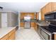 Modern kitchen with stainless steel appliances and wood cabinets at 5738 Scott White Rd, Hollywood, SC 29449
