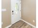 Bright entryway with white door, glass accents, and wood-look flooring at 5738 Scott White Rd, Hollywood, SC 29449