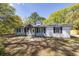 House exterior featuring a white ranch style home with black shutters and a covered porch at 5738 Scott White Rd, Hollywood, SC 29449