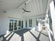 Spacious screened porch with whitewashed wood ceiling and grey flooring at 1467 Jeremy Cay Ct, Awendaw, SC 29429