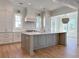 Spacious kitchen with white cabinets, center island, and stainless steel appliances at 1467 Jeremy Cay Ct, Awendaw, SC 29429