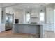 Modern kitchen with white cabinets, center island, and stainless steel appliances at 1467 Jeremy Cay Ct, Awendaw, SC 29429