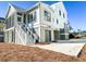 White two-story house with detached garage and landscaping at 1467 Jeremy Cay Ct, Awendaw, SC 29429