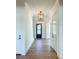 Bright hallway with hardwood floors, white walls, and a black door at 1467 Jeremy Cay Ct, Awendaw, SC 29429