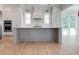 Open kitchen with white cabinets, large island, and stainless steel appliances at 1467 Jeremy Cay Ct, Awendaw, SC 29429