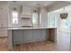 Bright kitchen featuring white cabinets, a large island, and a white brick backsplash at 1467 Jeremy Cay Ct, Awendaw, SC 29429