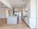 Modern kitchen with white cabinets, gray island, and light wood floors at 1467 Jeremy Cay Ct, Awendaw, SC 29429