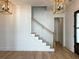 Elegant staircase with white railings and light wood steps at 1467 Jeremy Cay Ct, Awendaw, SC 29429