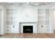 Living room with built-in shelving, fireplace, and hardwood floors at 1467 Jeremy Cay Ct, Awendaw, SC 29429