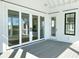 Sliding glass doors open to a spacious, screened porch at 1467 Jeremy Cay Ct, Awendaw, SC 29429