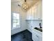 Laundry room with hexagon floor tile, white cabinets, and a farmhouse sink at 1467 Jeremy Cay Ct, Awendaw, SC 29429