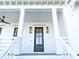 Dark brown front door with glass panes and sidelights at 1467 Jeremy Cay Ct, Awendaw, SC 29429