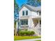 Two-story white farmhouse with gray accents and a charming front porch at 1480 Jeremy Cay Ct, Awendaw, SC 29429