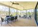 Relaxing screened porch with seating area and dining table at 1480 Jeremy Cay Ct, Awendaw, SC 29429