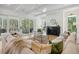 Spacious living room with a modern fireplace and large windows offering natural light at 1480 Jeremy Cay Ct, Awendaw, SC 29429