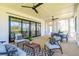 Large screened porch with seating and dining areas at 1480 Jeremy Cay Ct, Awendaw, SC 29429