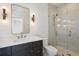 Modern bathroom with dark vanity, glass shower, and gold accents at 1480 Jeremy Cay Ct, Awendaw, SC 29429