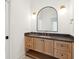 Light wood vanity with a dark countertop in this modern bathroom at 1480 Jeremy Cay Ct, Awendaw, SC 29429