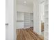 Bright walk-in closet with built-in shelving and rods at 1480 Jeremy Cay Ct, Awendaw, SC 29429