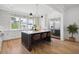 Spacious kitchen with white cabinets, quartz countertops, and a large island at 1480 Jeremy Cay Ct, Awendaw, SC 29429