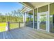 Wooden deck with access to a screened porch and backyard at 1480 Jeremy Cay Ct, Awendaw, SC 29429