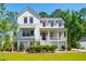 Stunning two-story farmhouse with gray accents and a spacious yard at 1480 Jeremy Cay Ct, Awendaw, SC 29429