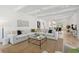 Bright living room with sectional sofa, coffee table, and large windows at 1480 Jeremy Cay Ct, Awendaw, SC 29429