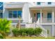 Close up of charming farmhouse exterior, showcasing stairs and landscaping at 1480 Jeremy Cay Ct, Awendaw, SC 29429