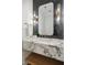 Modern powder room with marble vanity and dark tile at 1480 Jeremy Cay Ct, Awendaw, SC 29429