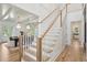 Elegant staircase leading to the second floor and overlooking the dining area at 1480 Jeremy Cay Ct, Awendaw, SC 29429