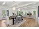 Open concept dining room with a dark wood table and hardwood floors at 1480 Jeremy Cay Ct, Awendaw, SC 29429